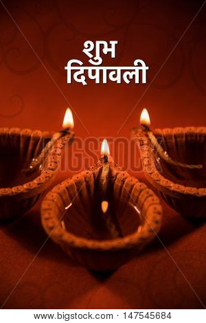 happy diwali or happy deepavali greeting card made using a photograph of diya or oil lamp