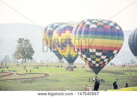 CHIANGRAI THAILAND - FEBRUARY 14 : Hot air Balloons ready to rise into the sky in the morning at SINGHA PARK CHIANGRAI BALLOON FIESTA 2016 Chiangrai province Thailand
