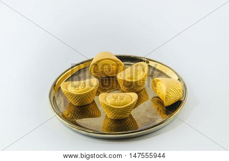 Gold ingot on golden plates white background