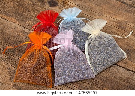several pouches of levender on a wooden table background