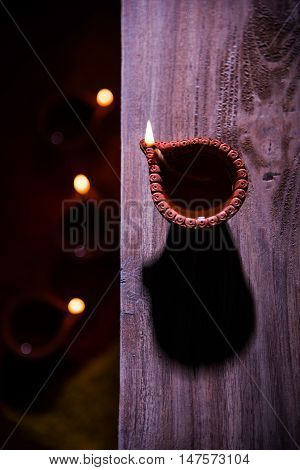 beautiful diwali diya with fire crackers and sweet pera, selective focus