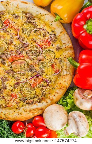 pizza with mincemeat and mushrooms vegetables cheese sauce and pickles fresh vegetables boletus Italian kitchen served in cafes restaurants pizzerias snack bars