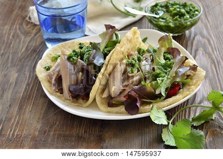 Tacos with chicken and vegetable salad with green sauce