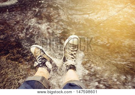 Feet Couple Man hiking outdoor Lifestyle Travel concept waterfall in the forest Vintage Tone