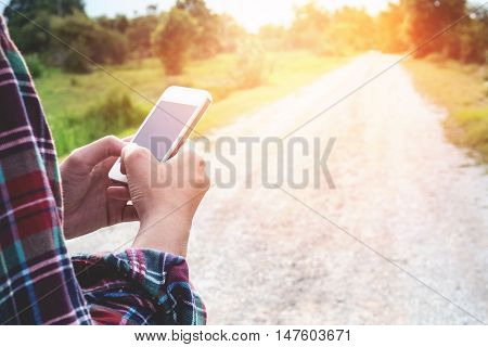 Traveler Man holding and using smartphone. travel concept vintage tone