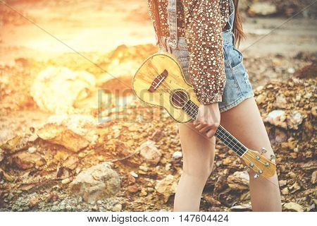 Young woman hand's holding Ukulele (Soft focus grain and vintage tone.)
