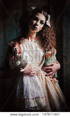 The strange scary girl with toys in hands. Grunge texture effect