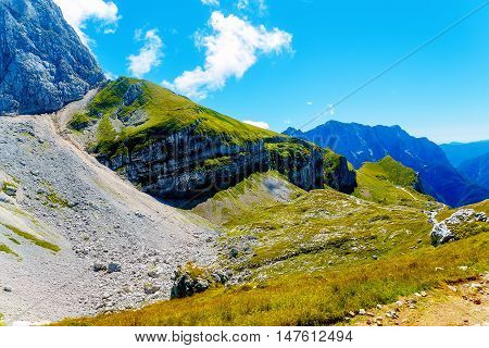 beautiful rocky cliff in alpine mountains on summer day