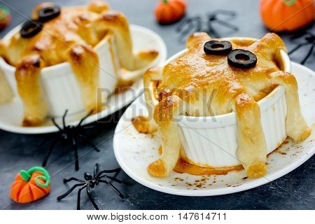 Halloween octopus pot pie. Tentacle pot pies. Portion pot pies with dough tentacles wrapping down the sides of the bowl. Funny idea for festive dinner. Adorable treats for Halloween party for kids