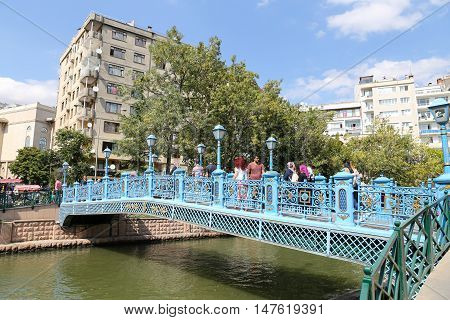 ESKISEHIR TURKEY - SEPTEMBER 03 2016: People passing over the bridge on Porsuk River. Porsuk river is one of the most populer touristy place with boat tours and entertainment in Eskisehir.