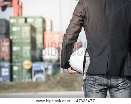 construction worker checking location site with crane on the background