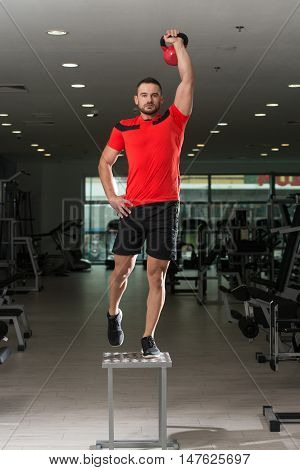 Fitness Instructor Doing Heavy Weight Exercise With Kettle-bell