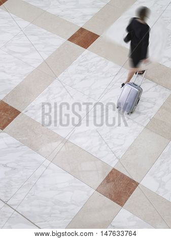 Woman out of focus walking through a lobby