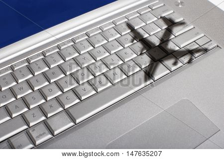 Shadow of a plane flying over a laptop