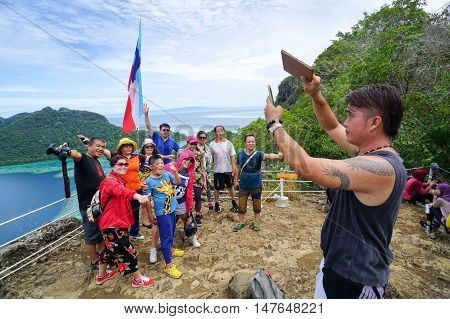 Semporna,Sabah-Sep 10,2016:Tourists enjoying amazing view from viewpoint National Park on top of Bohey Dulang island Semporna,Sabah.The bright blue water & rocky shore in the island of Semporna