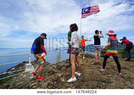 Semporna,Sabah-Sep 10,2016:Tourists enjoying amazing view from viewpoint National Park on top of Bohey Dulang island Semporna,Sabah.The bright blue water & rocky shore in the island of Semporna
