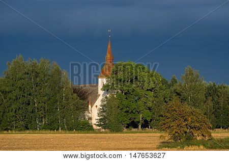 Mary's Church grain field blue sky and natural environment. Torma in the summer small village in Estonia. Europe