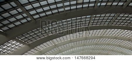 Part of architecture made of glass and metal beams.
