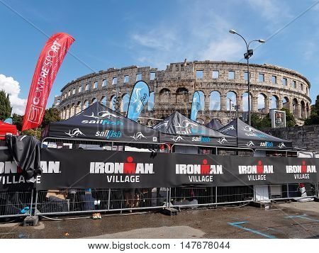 PULA, CROATIA - SEPTEMBER 17, 2016 - Ironman village open stores in front of amphitheater in Pula Croatia on September 17 2016.