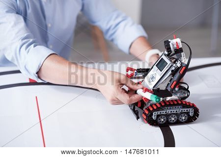 Do the job. Robot conducts human function capably oparating with his plastic hands