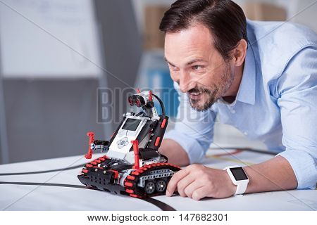 Science is fun. Exited engineer giving a try to his new invention