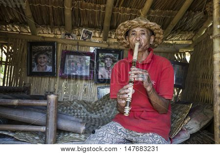 Ubud Bali Indonesia September 10th 2016: old man playing a flute
