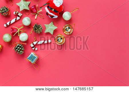 Top view Christmas decoration and Santa Claus doll on red background with copy space.