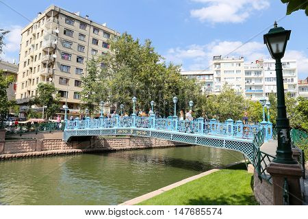 ESKISEHIR TURKEY - SEPTEMBER 03 2016: People passing over the bridge on Porsuk River. Porsuk river is one of the most populer touristy place with boat tours and entertainment in Eskisehir.
