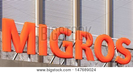 Rapperswil, Switzerland - September 12, 2016: Migros sign above the entrance of a Migros department store. Migros is Switzerland's largest retail company its largest supermarket chain and the largest employer.