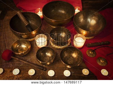 Studio shot of Tibetan singing bowls with burning candles