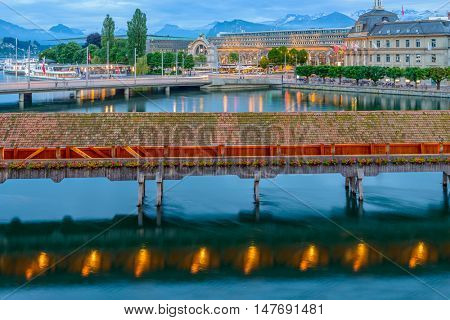 Night view towards Chapel Bridge (Kapellbruecke) together with the octagonal tall tower (Wasserturm) it is one of the Lucerne's most famous tourists attraction