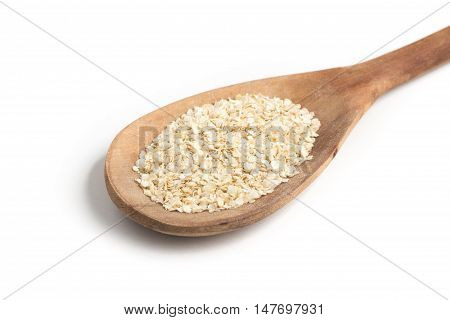 Quinoa Flakes into a spoon isolated in white background.