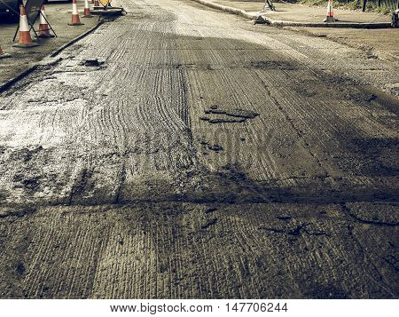 Vintage looking Paving works to remove and lay new tarmac asphalt on a road