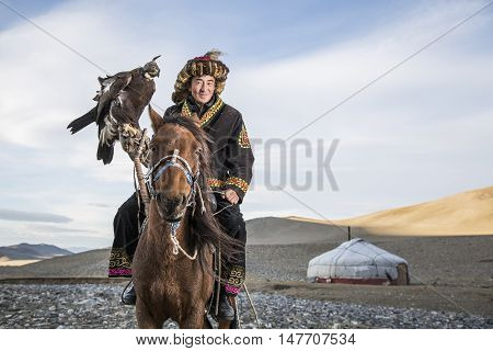 Bayan Ulgii Mongolia September 30th 2015: Mongolian eagle hunter with his eagle and horse