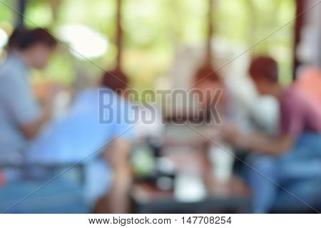 Abstract blurred people brainstorming in coffee shop business team meeting concept