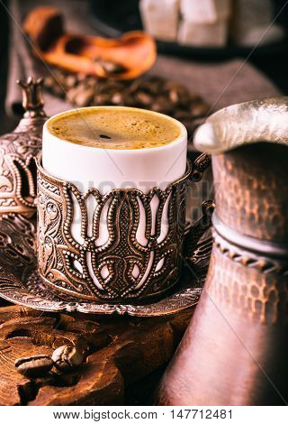 Turkish coffee cup on table. Embossed metal cup
