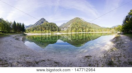 Crystal clear blue water lake and mountains. Panorama of wild landscape natural environment. Julian Alps Triglav National Park in Slovenia.