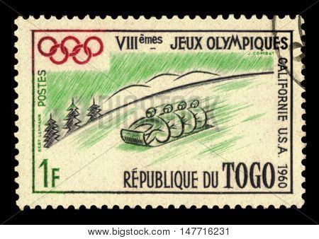 TOGO - CIRCA 1960: A stamp printed in Togo shows the Bobsleigh at the Winter Olympic Games in Squaw Valley with inscription and name of the series 