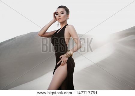 Professional photo shoot in desert. Beautiful sexy asian woman model in desert