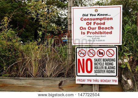A sign in Ocean Beach Fire Island NY that sais no eating skating biking roller blading and scooter riding