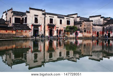 HONGCUN, CHINA - APRIL 20, 2014: Tourist walking on the street in ancient Hongcun Village of Anhui Province.