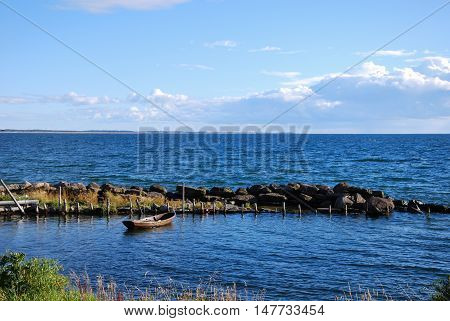 Small rowing boat in an old harbor at the swedish island Oland in the Baltic Sea