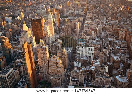 New York City rooftop view with downtown Manhattan skyscrapers and urban cityscape.