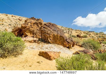 Boulders on the hill in Makhtesh Gadol or Large Crater, nature reserve in Negev desert, Israel