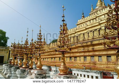 Golden umbrellas at the foot of The Great Dragon pagoda in Bagan is gilded with gold leaves. It is also called Shwezigon pagoda. Shwezigon is the top destination in Bagan, Manday.