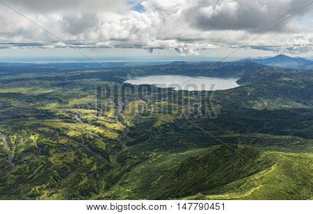 Crater Karymsky Lake. Kronotsky Nature Reserve on Kamchatka Peninsula. View from helicopter.