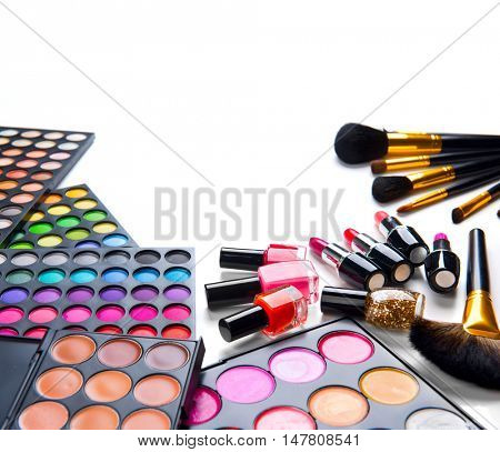 Makeup. Make-up Set Palette with colorful eyeshadows. Various cosmetics Brushes, lipgloss, lipstick, rouge, eyeshadow tints, foundation isolated on a white background. Make up artist tools