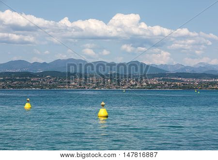 Landscape of the coast of Sirmione peninsula which divides the lower part of Lake Garda. It is a famous vacation place for a long time in northern Italy.