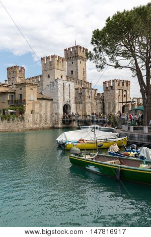 SIRMIONE ITALY - MAY 5, 2016: Sirmione - Italian small city on Garda lake with boats and castle