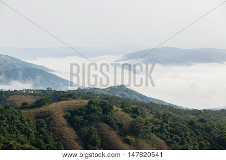 Cloud mist moves through rural valley hills scenic landscape.